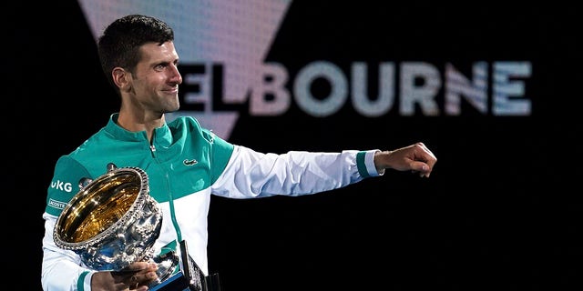 Serbia's Novak Djokovic holds the Norman Brookes Challenge Cup after defeating Russia's Daniil Medvedev in the men's singles final at the Australian Open tennis championship in Melbourne, Australia, Sunday, Feb. 21, 2021. 