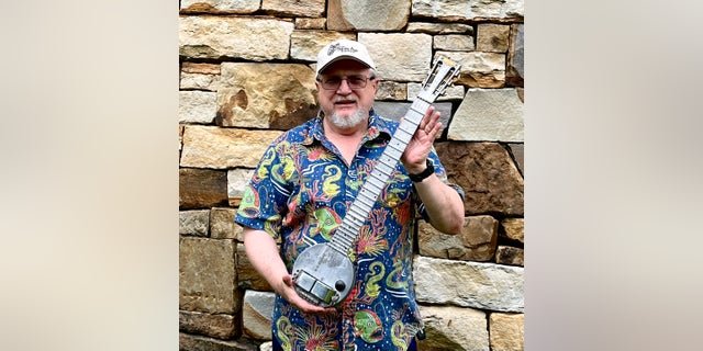 Indiana University professor and instrument collector Nicholas Toth displays his circa 1934 Rickenbacker Frying Pan, the earliest electric guitar. He purchased it at Gruhn Guitars in Nashville in 2022 and loaned it to the Rock Hall of Fame in Cleveland.