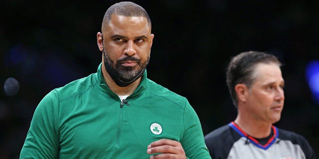 Celtics head coach Ime Udoka (left) did not agree with a referee (right) in the second quarter. The Boston Celtics hosted the Golden State Warriors for Game Six of the NBA Finals at the TD Garden in Boston on June 17, 2022. 