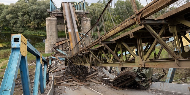 IZIUM, UKRAINE - SEPTEMBER 20: A Russian tank and a destroyed bridge are seen September 20, 2022, in Izium, Ukraine. Izium had been occupied by Russians since April 1st, causing major destruction and death to the small city. In recent weeks, Ukrainian forces have reclaimed villages east and south of Kharkiv, as Russian forces have withdrawn from areas they had occupied since early in the war. 