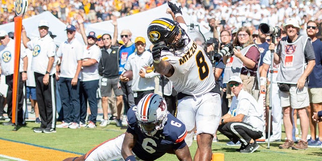 Linebacker Eugene Asante #9 of the Auburn Tigers chases after the loose ball as running back Nathaniel Peat #8 of the Missouri Tigers fumbles during the overtime period at Jordan-Hare Stadium on Sept. 24, 2022 in Auburn, Alabama. 