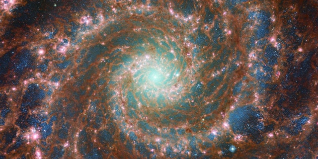 The M74 galaxy shines at its brightest in this combined optical/mid-infrared image, featuring data from both the NASA/ESA Hubble Space Telescope and the NASA/ESA/CSA James Webb Space Telescope. With Hubble’s venerable Advanced Camera for Surveys (ACS) and Webb’s powerful Mid-InfraRed Instrument (MIRI) capturing a range of wavelengths, this image has remarkable depth. 