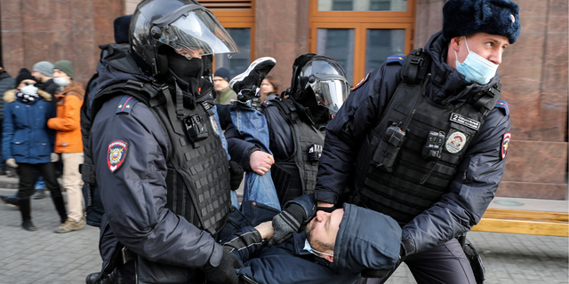  Russian Police officers detain a man during an unsanctioned protest rally against the military invasion in Ukraine on March 6, 2022 in Moscow, Russia. Russia invaded neighboring Ukraine on 24th February 2022, its actions have met with worldwide condemnation with rallies, protests and peace marches taking place in cities across the globe.