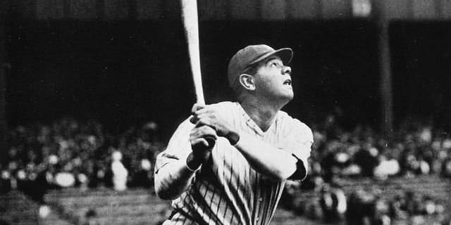 Babe Ruth takes a mighty swing during pre-game batting practice in Yankee Stadium. He hit 60 home runs in 1927, a record that stood for 34 years and still stands as a monumental achievement today.