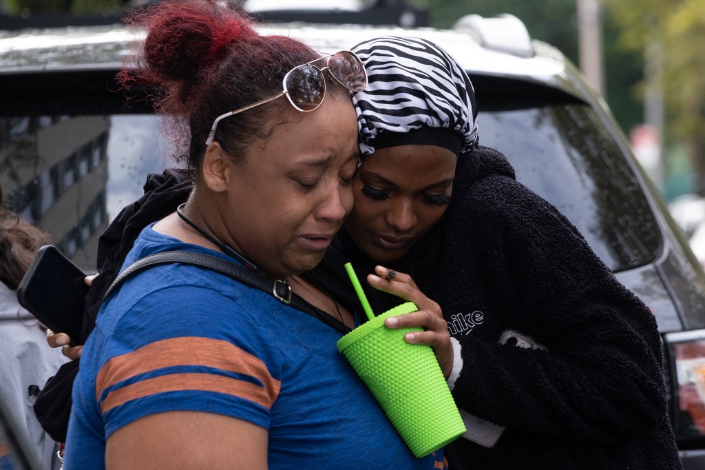 Stephanie Harris, left, and Tierra Banputten react to the horrific discovery.