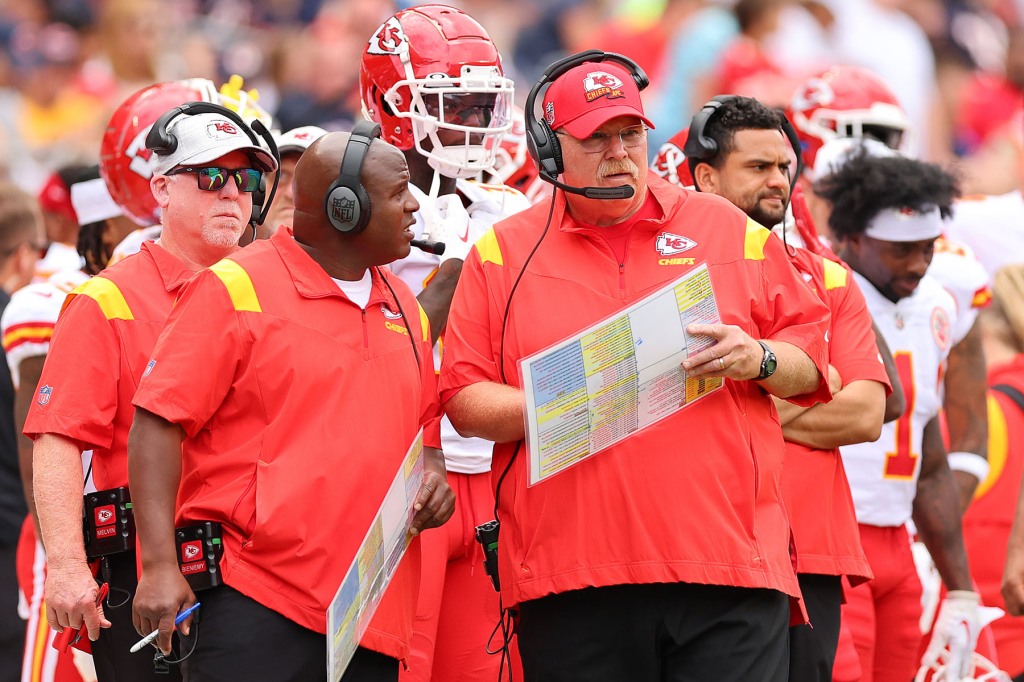 Offensive coordinator Eric Bieniemy and head coach Andy Reid of the Kansas City Chiefs talk against the Chicago Bears during the first half of the preseason game at Soldier Field on August 13, 2022 in Chicago, Illinois.