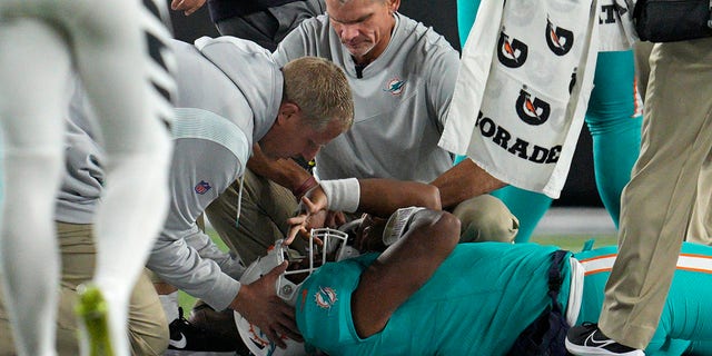 Miami Dolphins quarterback Tua Tagovailoa is examined during the first half of the team's NFL football game against the Cincinnati Bengals, Thursday, Sept. 29, 2022, in Cincinnati. 