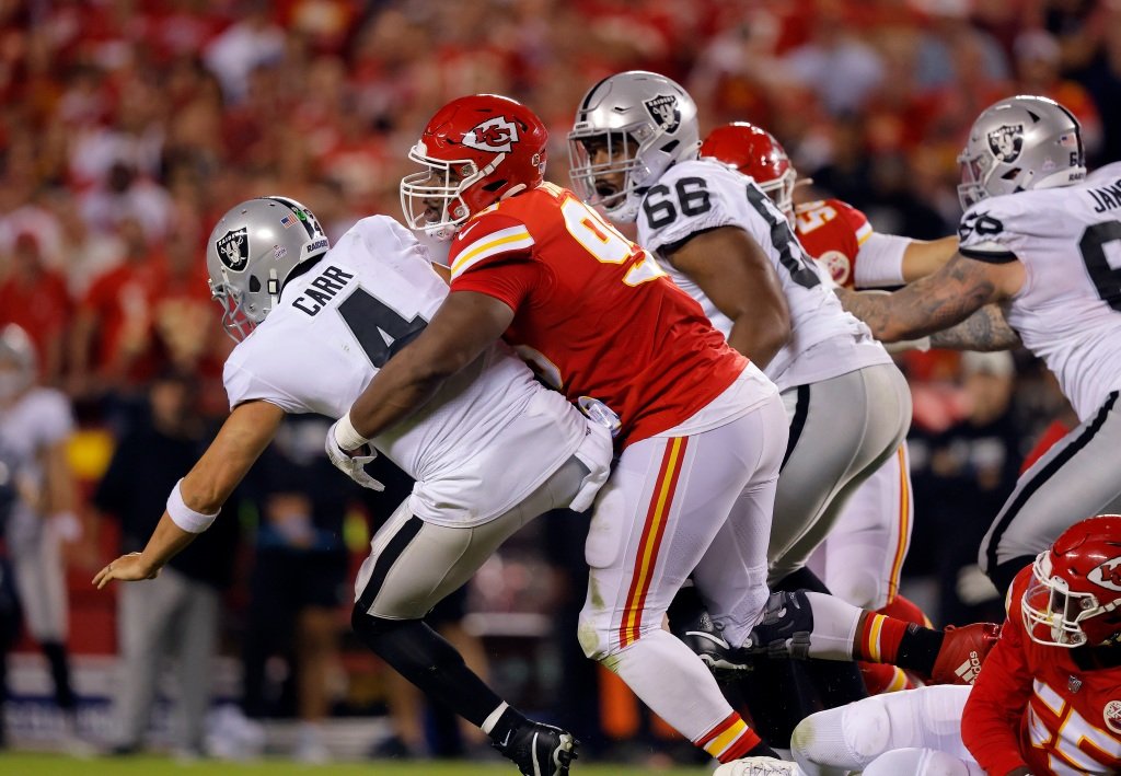 Derek Carr #4 of the Las Vegas Raiders is sacked by Chris Jones #95 of the Kansas City Chiefs during the 2nd quarter of the game at Arrowhead Stadium on October 10, 2022 in Kansas City, Missouri. Jones was called for a penalty for roughing the passer.