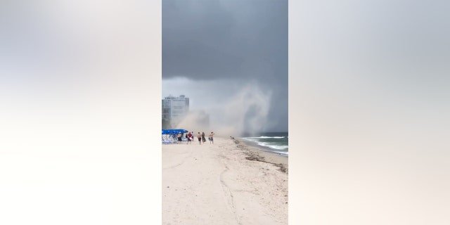 It only took a few seconds before the sand storm started picking up items off the beach. 