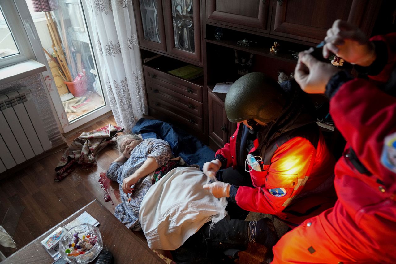 Paramedics treat an elderly woman wounded by shelling before transferring her to a hospital in Mariupol on March 2.