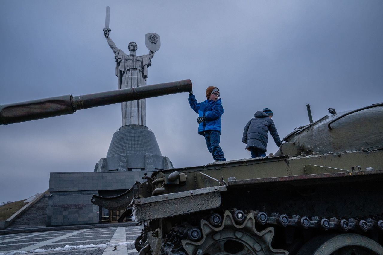 Children play on old Soviet tanks in front of the Motherland Monument in Kyiv on February 16.