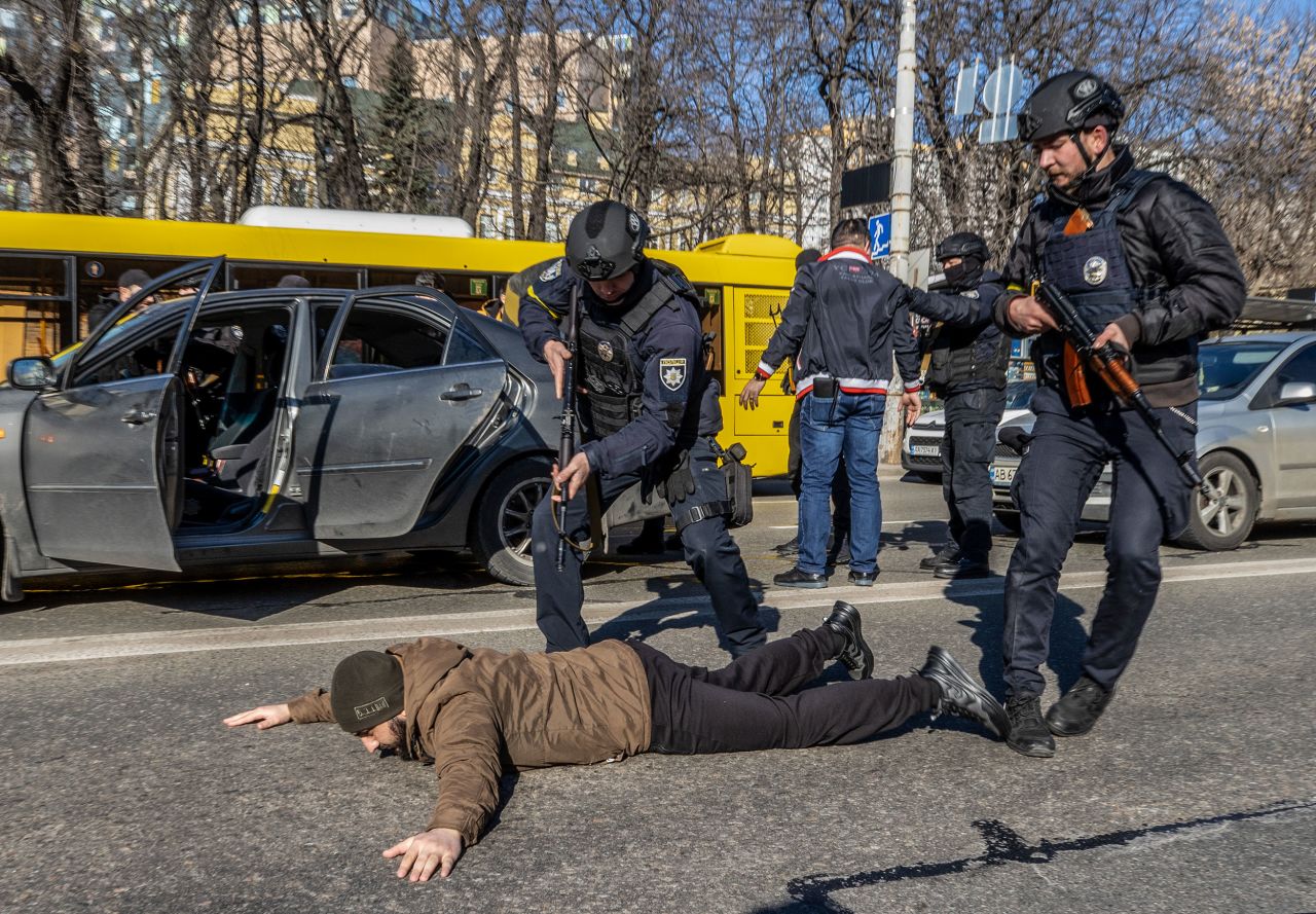 Ukrainian forces order a man to the ground on February 28 as they increased security measures amid Russian attacks in Kyiv.
