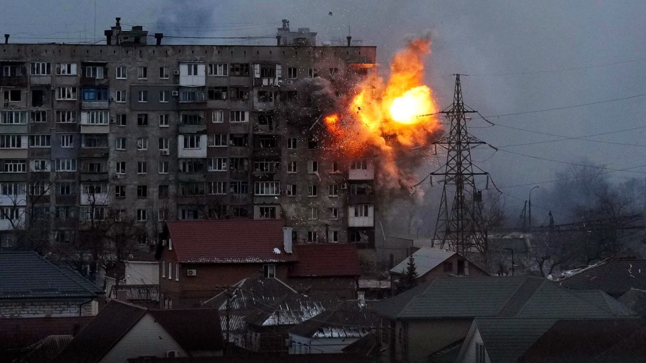 An explosion is seen at an apartment building in Mariupol on March 11. The city in southeastern Ukraine has been <a href=