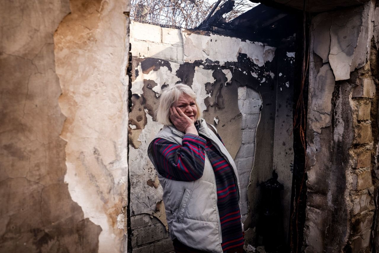 Svetlana Ilyuhina looks at the wreckage of her home in Kyiv following a Russian rocket attack on March 23. 