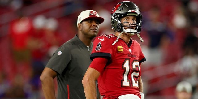 Offensive coordinator Byron Leftwich and Tom Brady, #12 of the Tampa Bay Buccaneers, look on prior to a game against the Baltimore Ravens at Raymond James Stadium on Oct. 27, 2022 in Tampa, Florida.