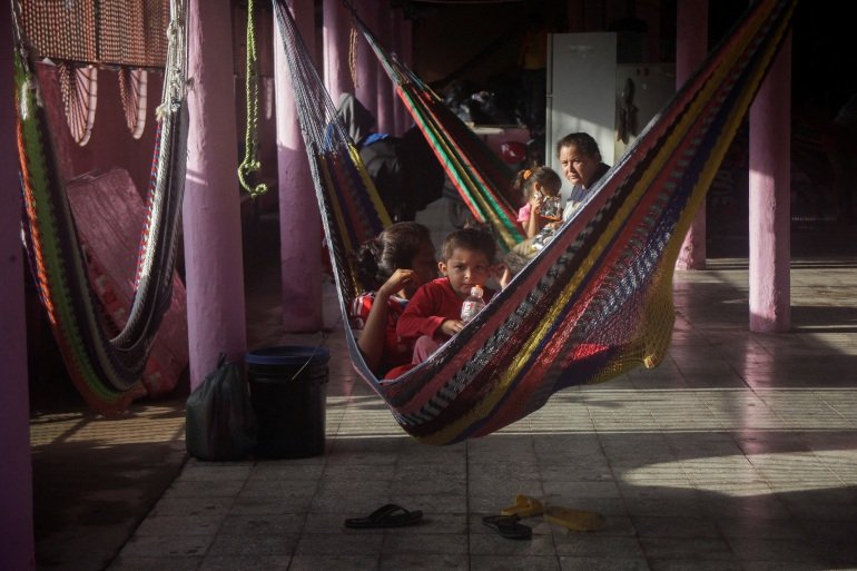 People rest in hammocks at a temporary shelter after storm Julia in Honduras.