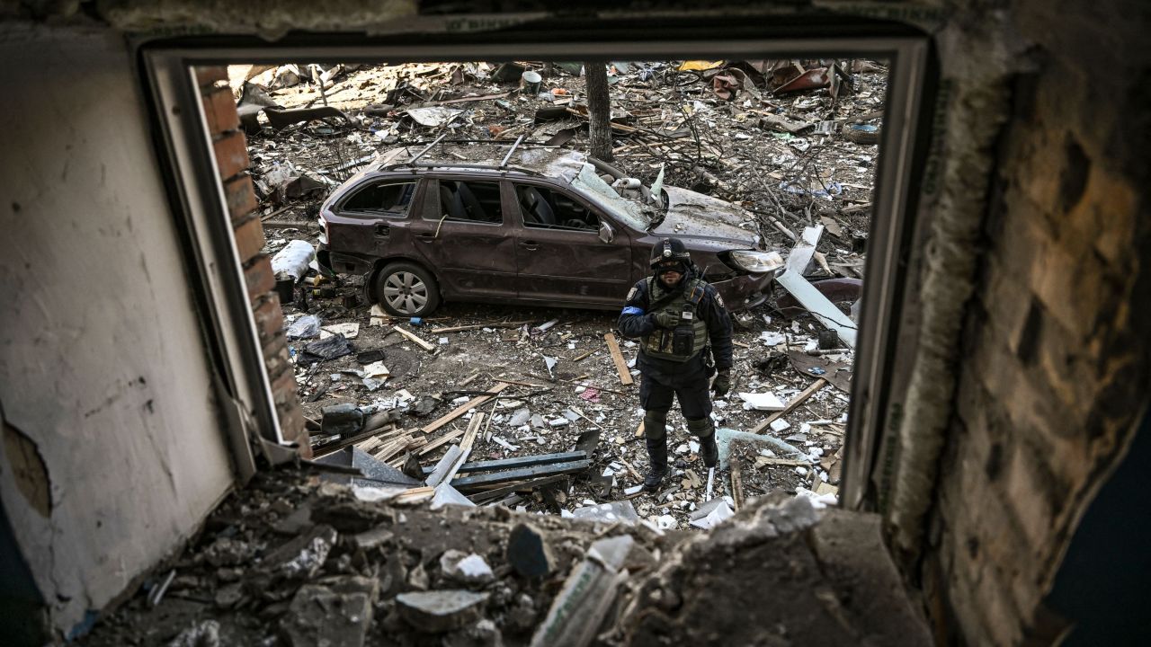 A Ukrainian serviceman stands among debris after shelling in a residential area in Kyiv on March 18. 