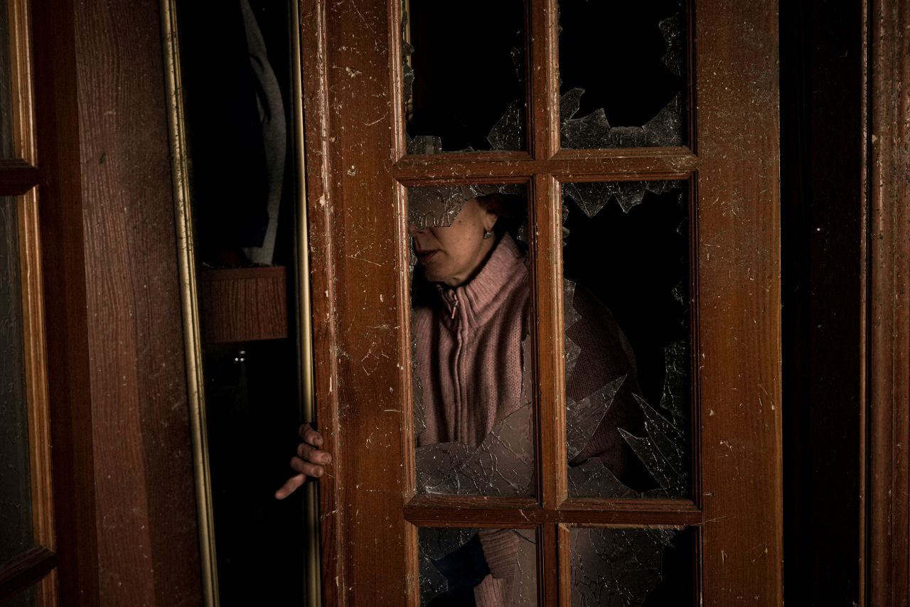 A woman cleans up a room March 21 in a building that was damaged by bombing in Kyiv.