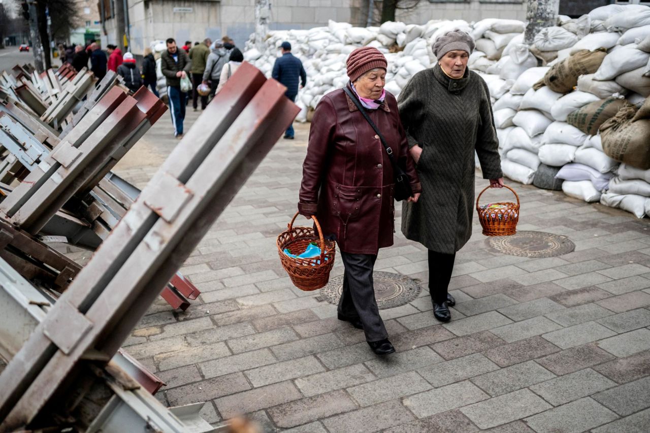 Women walk between sandbags and anti-tank barricades in Zhytomyr, Ukraine, to attend a blessing of traditional Easter food baskets on April 23.