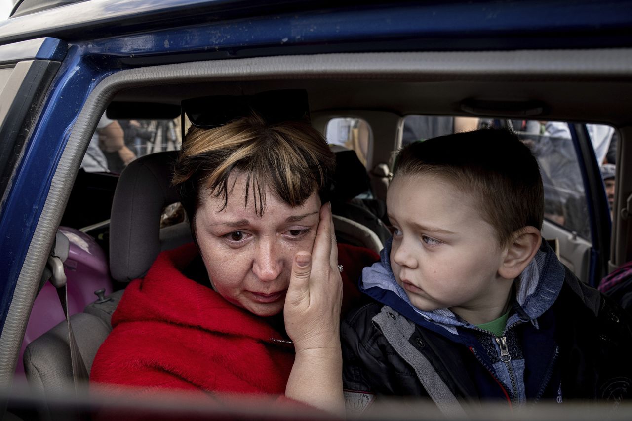Natalia Pototska cries next to her grandson Matviy as they arrive at a center for displaced people in Zaporizhzhia on May 2.
