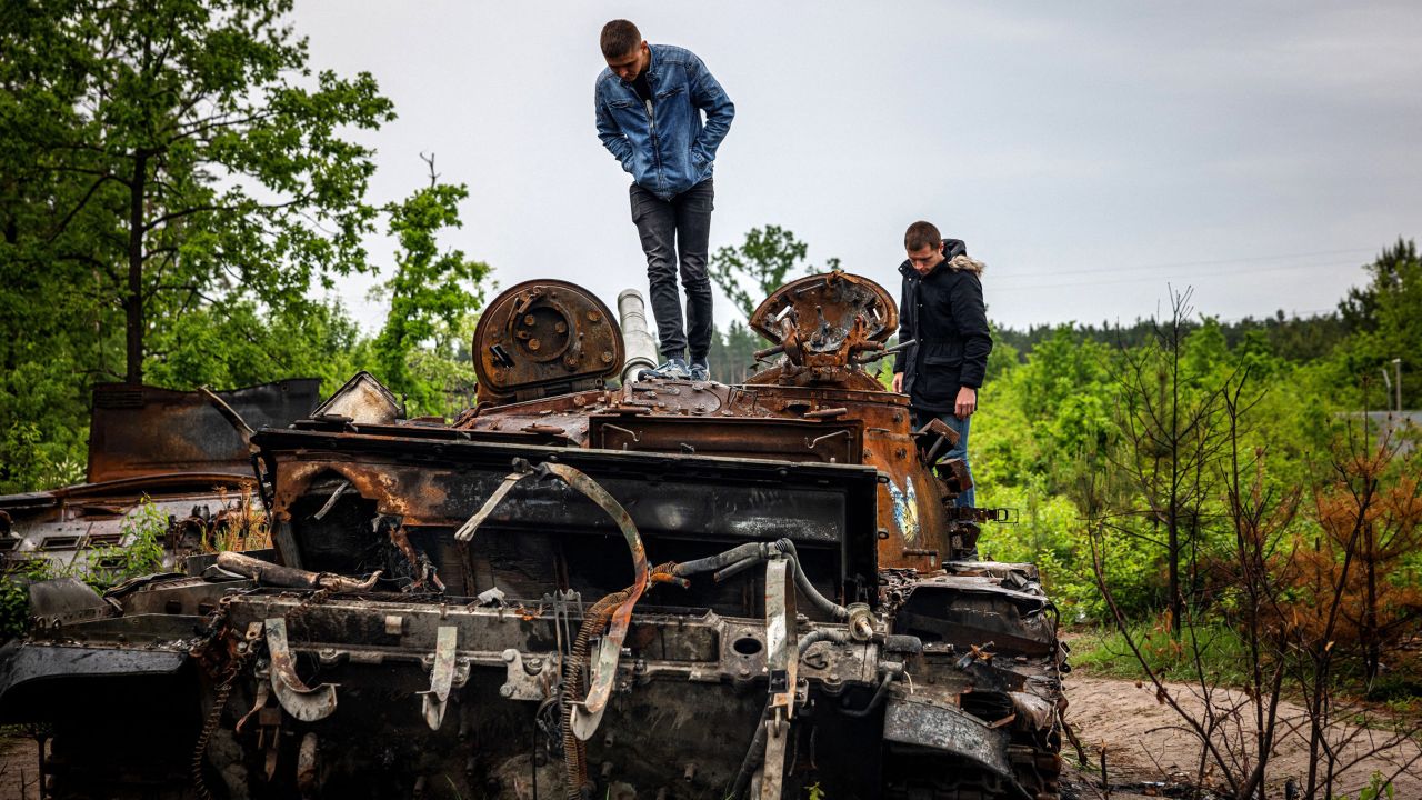Local residents examine a destroyed Russian tank outside of Kyiv, Ukraine, on Tuesday, May 31. It has now been 100 days since Russia invaded.
