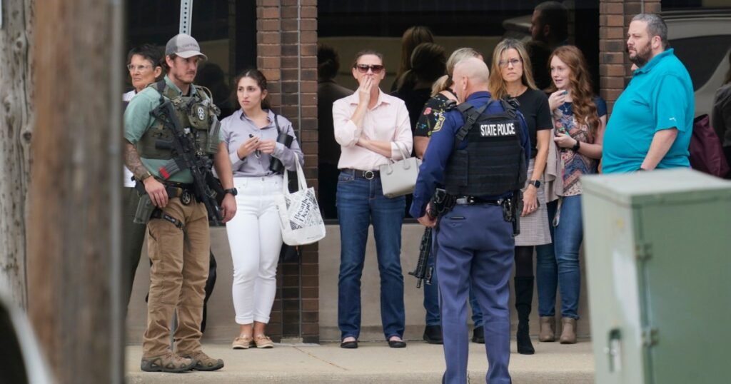 Man, 34, charged with murder in Michigan hotel shooting that left worker dead