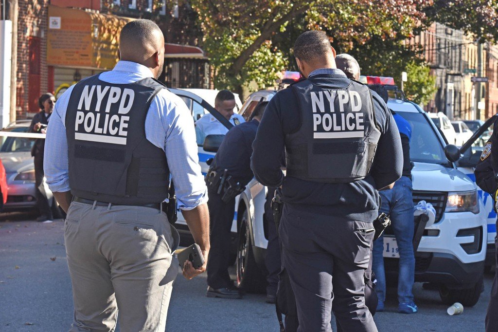 A group of officers at the scene of the shooting, 2315 Strauss Street.