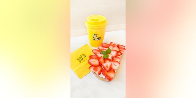 The café is known for its yellow coffee cups that have encouraging and complimenting statements printed on them.