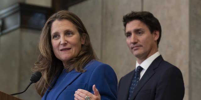 Canadian Prime Minister Justin Trudeau looks on as Deputy Prime Minister and Finance Minister Chrystia Freeland speaks after announcing sanctions on Iran, in Ottawa, Friday, Oct. 7, 2022.