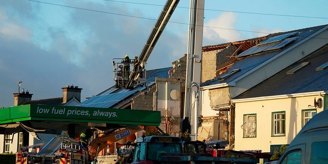 Emergency services work at the scene of an explosion at Applegreen service station in the village of Creeslough in Co Donegal, Ireland, Saturday, Oct. 8, 2022.