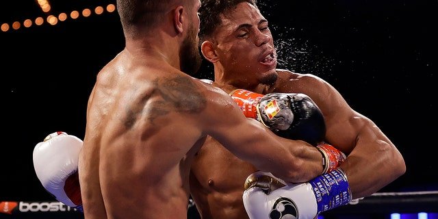 Vasiliy Lomachenko punches Jamaine Ortiz, right, during a lightweight boxing match Saturday, Oct. 29, 2022, in New York.