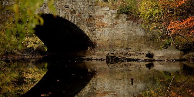 Fall color reflections at the Blackstone River in Whitinsville, Massachusetts.