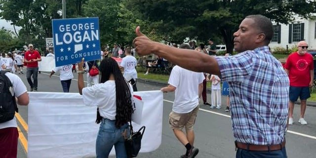 Republican Congressional nominee George Logan marches in a parade in Newtown, Connecticut, on Sept. 5, 2022