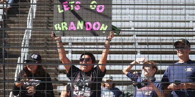 A NASCAR fan holds a "Lets Go Brandon!" sign during the NASCAR Xfinity Series Andy's Frozen Custard 335 at Texas Motor Speedway on Oct. 16, 2021 in Fort Worth, Texas.