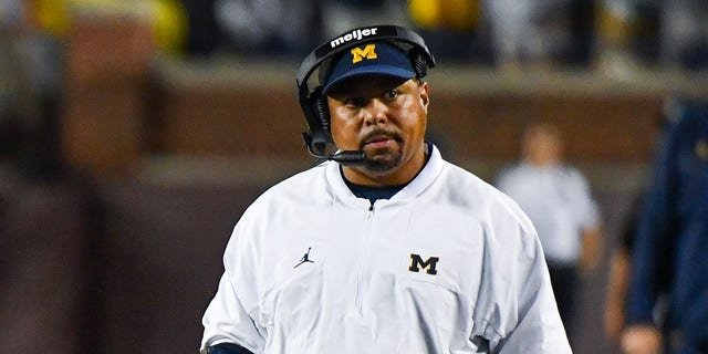 Blake Corum #2 (L) and Assistant Coach Mike Hart (R) of the Michigan Wolverines are seen during the second half of a college football game against the Hawaii Rainbow Warriors at Michigan Stadium on Sept. 10, 2022 in Ann Arbor, Michigan. The Michigan Wolverines won the game 56-10 over the Hawaii Rainbow Warriors.