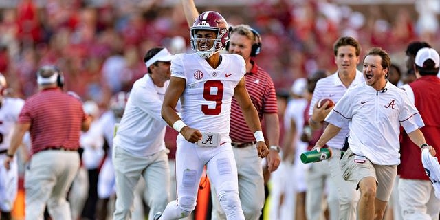Bryce Young, #9 of the Alabama Crimson Tide, celebrates on the sidelines after his team scored a touchdown during a game against the Arkansas Razorbacks at Donald W. Reynolds Razorback Stadium on Oct. 1, 2022 in Fayetteville, Arkansas. The Crimson Tide defeated the Razorbacks 49-26.