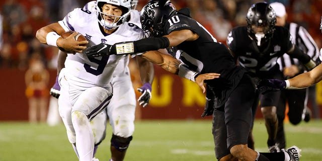 Quarterback Adrian Martinez, #9 of the Kansas State Wildcats, is tackled by defensive back Darien Porter, #10 of the Iowa State Cyclones, as he scrambles for yards in the second half of play at Jack Trice Stadium on Oct. 8, 2022 in Ames, Iowa. The Kansas State Wildcats won 10-9 over the Iowa State Cyclones.