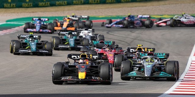 Red Bull driver Max Verstappen, front, of the Netherlands, leads Mercedes driver Lewis Hamilton, right, of Britain, and the rest of the field during the Formula One U.S. Grand Prix auto race at Circuit of the Americas, Sunday, Oct. 23, 2022, in Austin, Texas.