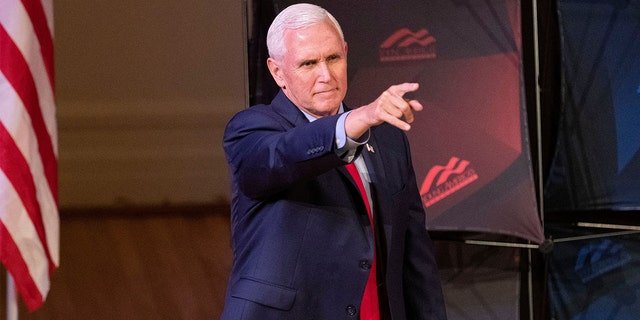 Former Vice President Mike Pence points as he arrives to speak at a campus lecture hosted by Young Americans for Freedom at the University of Virginia in Charlottesville, Va., April 12, 2022.