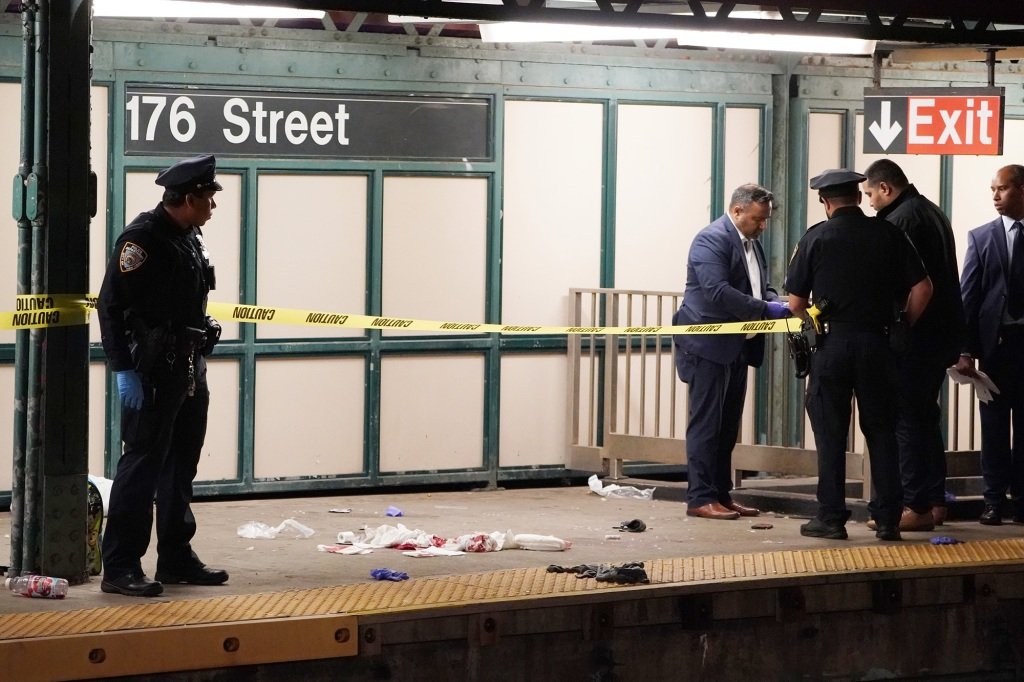 Police investigate at the scene of the unprovoked stabbing. 