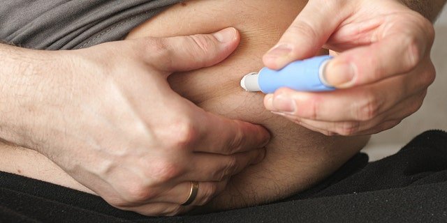 A man injects Semaglutide Ozempic to control his blood sugar levels.