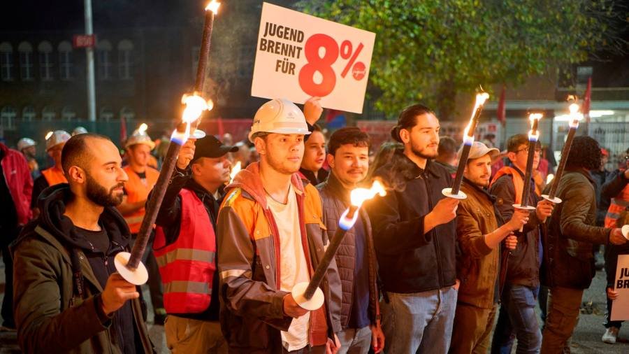 German industrial workers fire warning shot with strikes over pay
