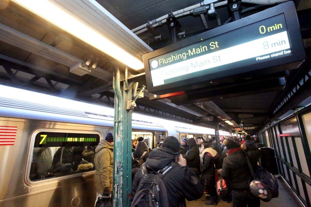 A picture of a subway station sign at the Flushing Main Street subway station.