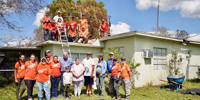 Rev. Franklin Graham (center, in blue shirt), along with Samaritan's Purse team members and volunteers, help those whose homes were hit by Hurricane Ian in southwestern Florida.