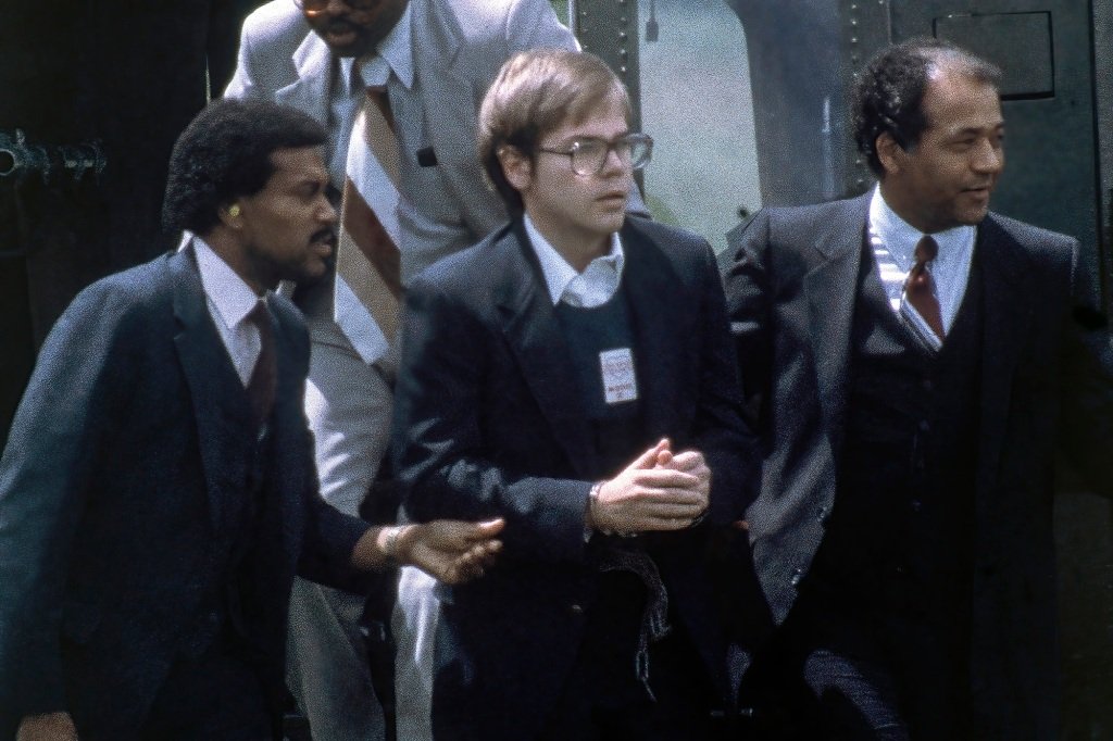 U.S. Marshals escort John Hinckley Jr. as he returns to a marine base via helicopter in Quantico, Va., Aug. 8, 1981