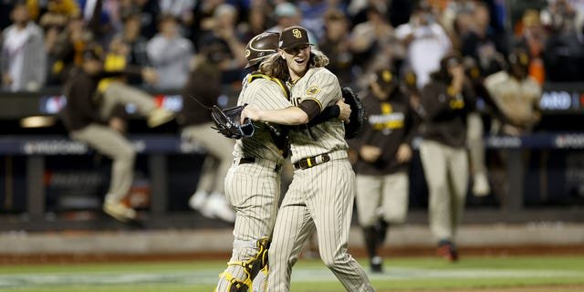Josh Hader #71 of the San Diego Padres celebrates with Austin Nola #26 after defeating the New York Mets in game three to win the National League Wild Card Series at Citi Field on October 09, 2022 in the Flushing neighborhood of the Queens borough of New York City. the San Diego Padres defeated the New York Mets with a score of 6 to 0.