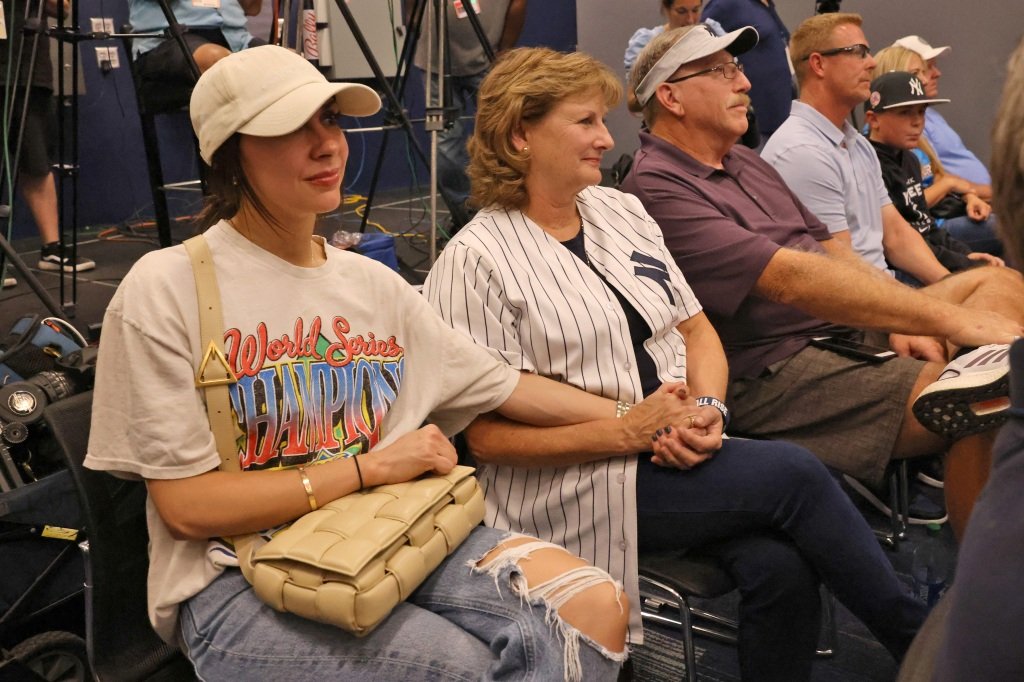 Aaron Judge’s wife Samantha Bracksieck holding hands with Judge's mom, Patty, who is sitting next to his dad Wayne Judge at a press conference after hitting his 62nd of the season, which passes Roger Maris, Jr.