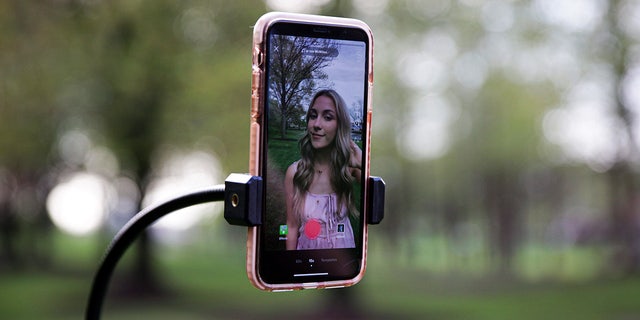 Katie Feeney, an 18-year-old TikTok creator, records a TikTok video at Rio Park in Gaithersburg, Md., on April 15, 2021.  