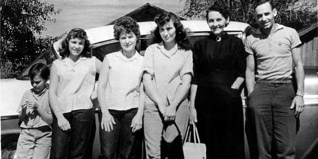 Country singer Loretta Lynn poses for a portrait with her family in 1955 in Butcher Holler, Kentucky. 