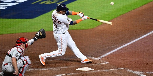 Martin Maldonado (15) of the Houston Astros hits an RBI single in the second inning during Game 1 of the 2022 World Series against the Philadelphia Phillies at Minute Maid Park Friday, Oct. 28, 2022, in Houston.
